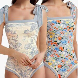 SALE! Reversible Floral/ Blue 1-piece swim. New. No tags. Size 6-8. Skays.